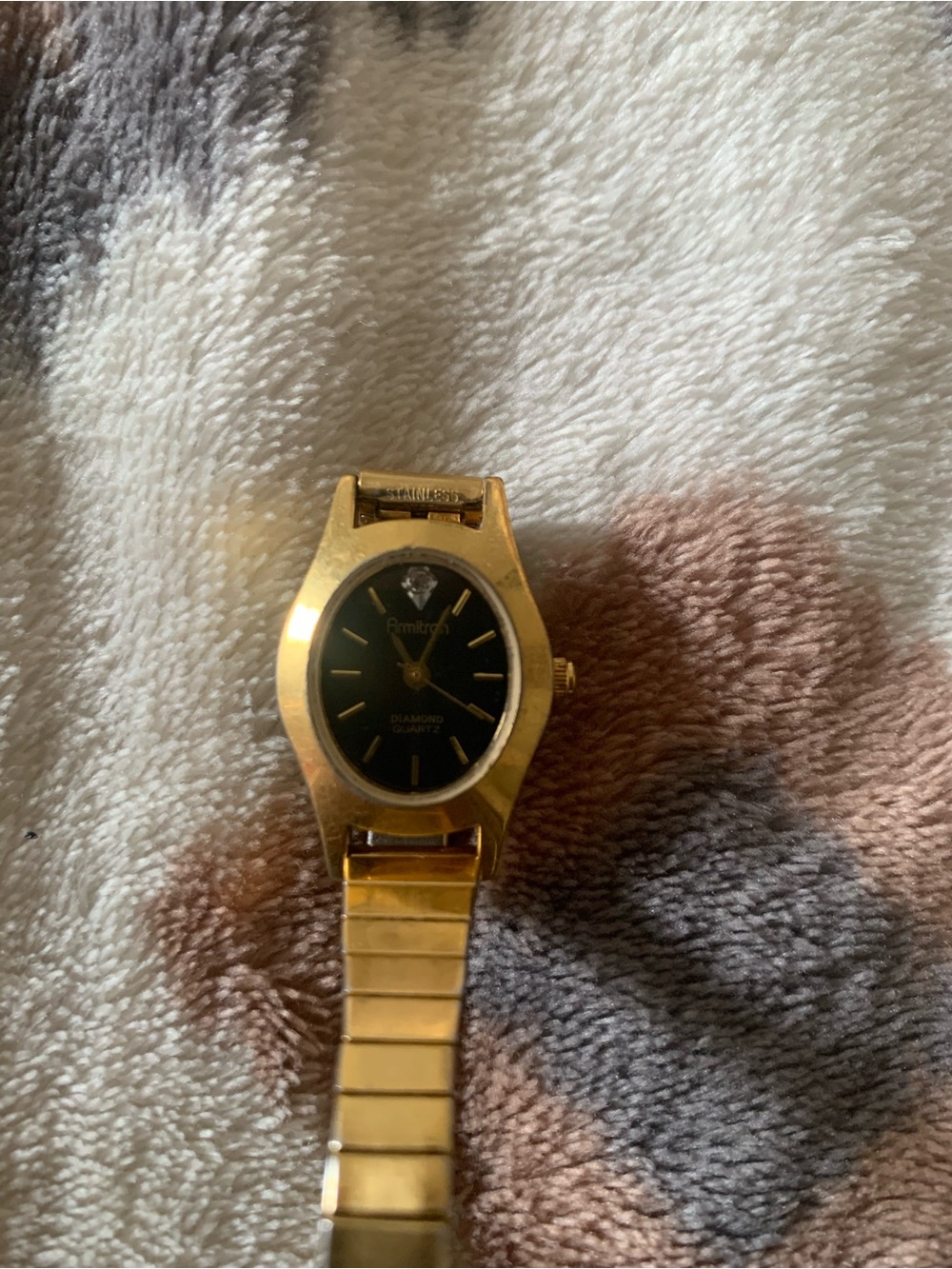 Armitron gold tone with black dial womens watch on stretch bracelet
